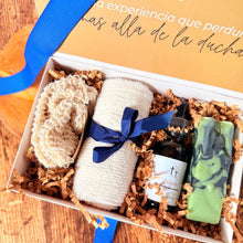 Cargar imagen en el visor de la galería, Caja masculina artesanal con lazo azul, jabón en barra, aceite para barba, toalla y bolsita de sisal sobre fondo de madera.
